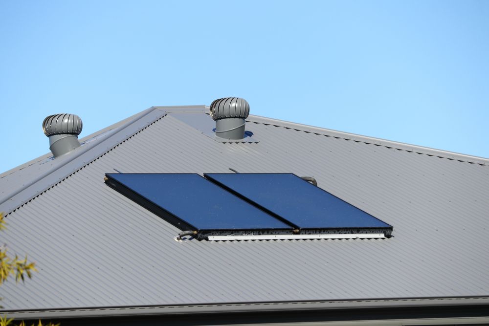 A metal roof with solar panels and two whirlybirds — Kerney Plumbing in Bacchus Marsh, VIC