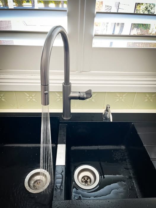 Kitchen Sink With Tall Faucet Running Water Into a Black Double Basin Sink  — Kerney Plumbing in Bacchus Marsh, VIC
