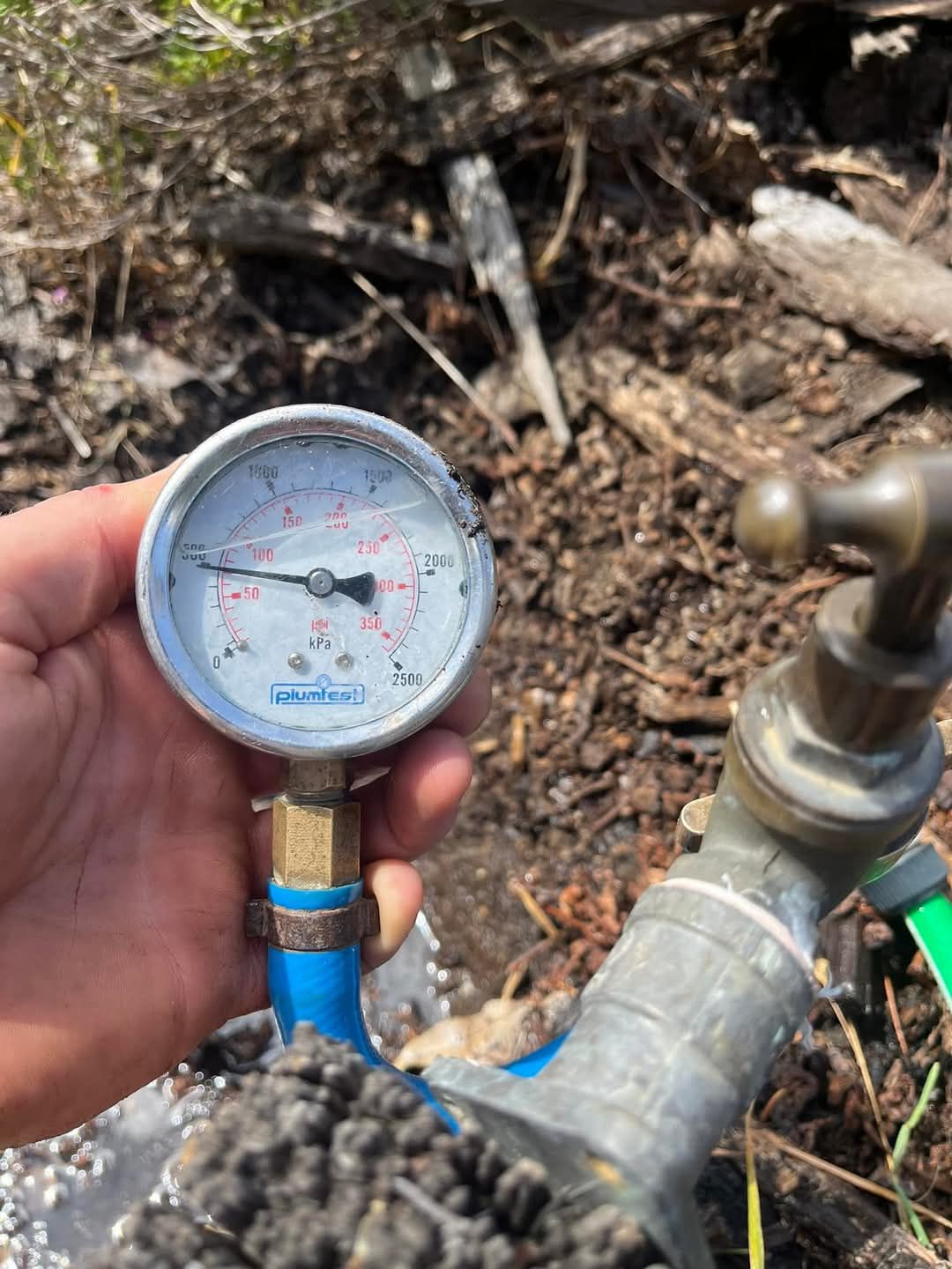 A Pressure Gauge is Sitting on Top of a Tree Stump — Kerney Plumbing in Bacchus Marsh, VIC