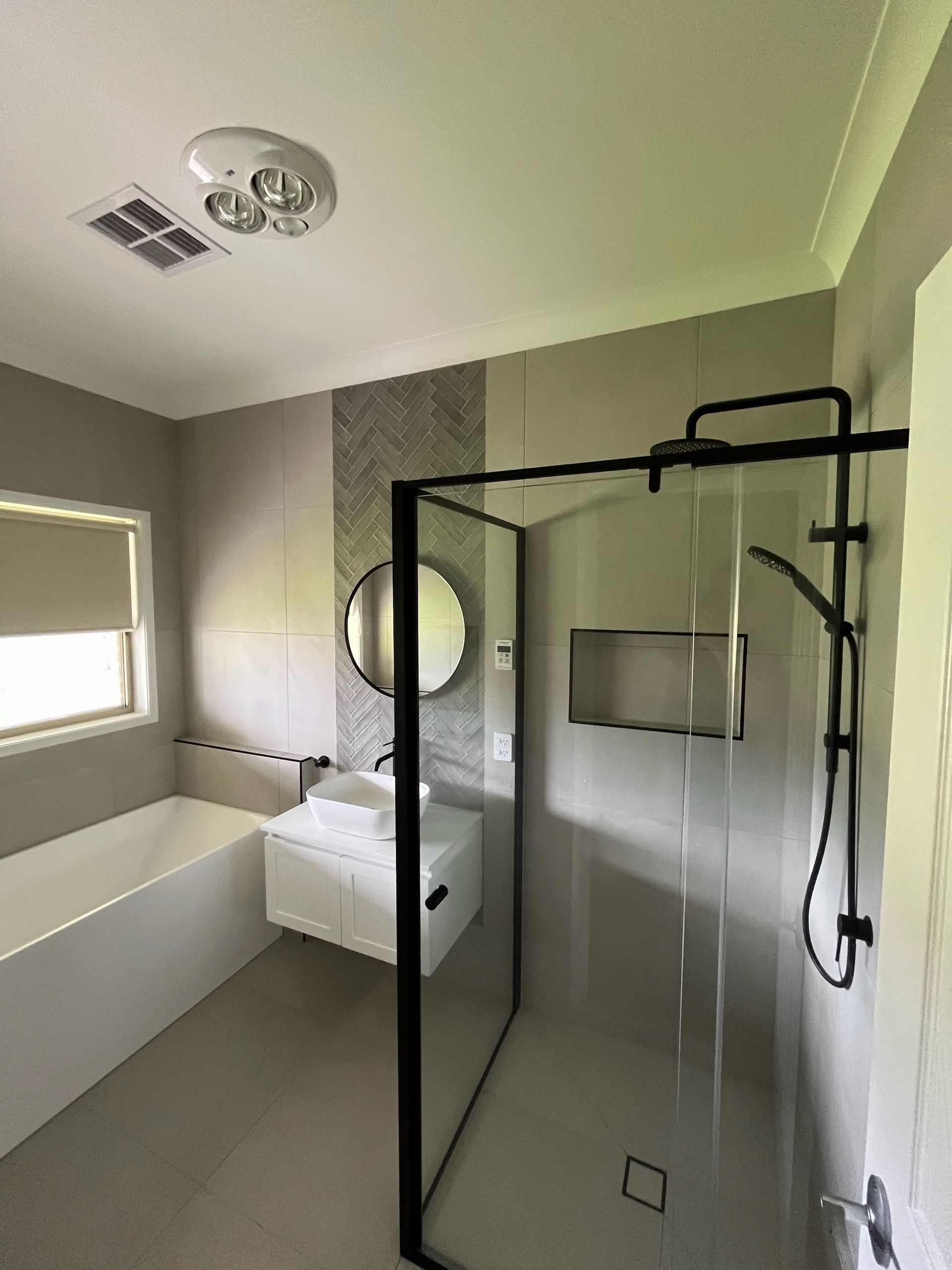 A Bathroom With a Toilet, Sink and Shower — Kerney Plumbing in Bacchus Marsh, VIC