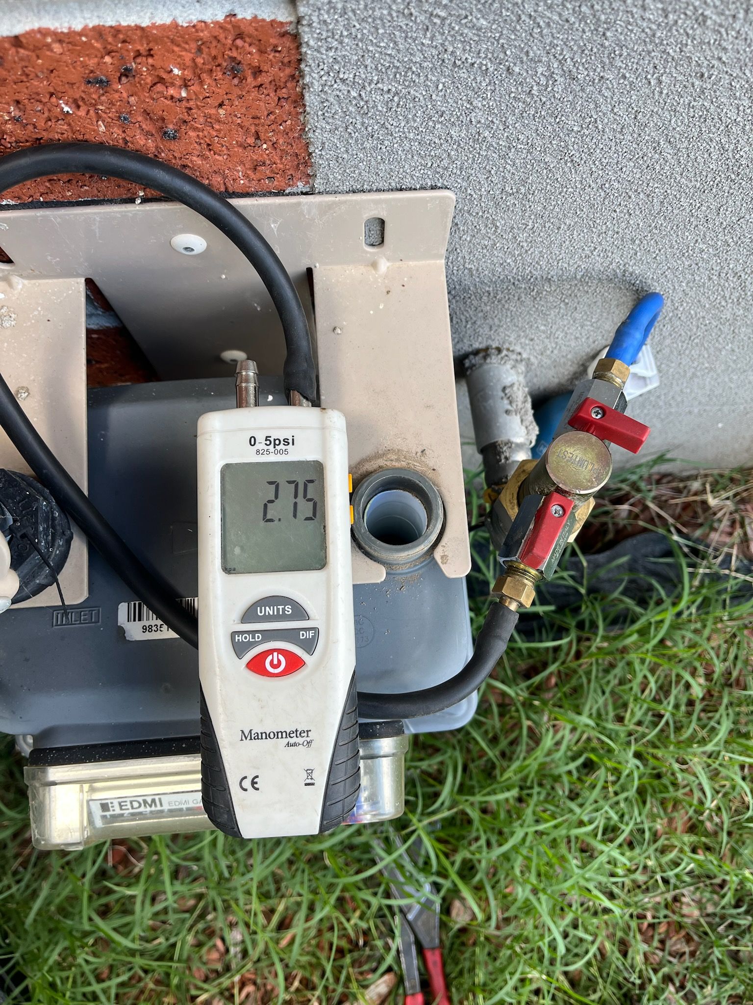 A Person Wearing Blue Gloves is Holding a Blue Pipe — Kerney Plumbing in Melton, VIC