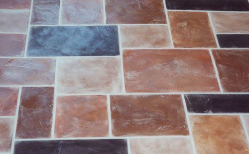 Brick-patterned tile floor with various brown, tan, and gray rectangles.