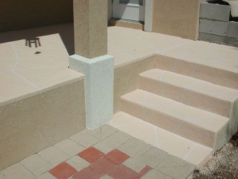 Beige and tan exterior with steps, pillar, and patterned brickwork.