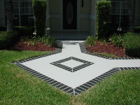 Red brick-like tiles with white grout in a patterned layout, likely a floor or patio.