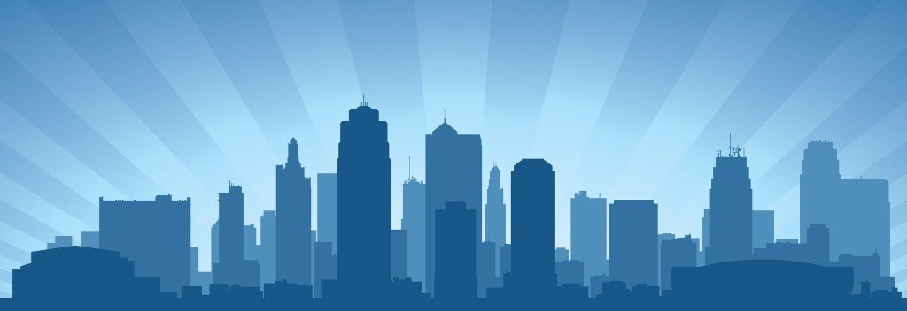 Silhouette of Kansas City tax services skyline in shades of blue with a sunburst background.
