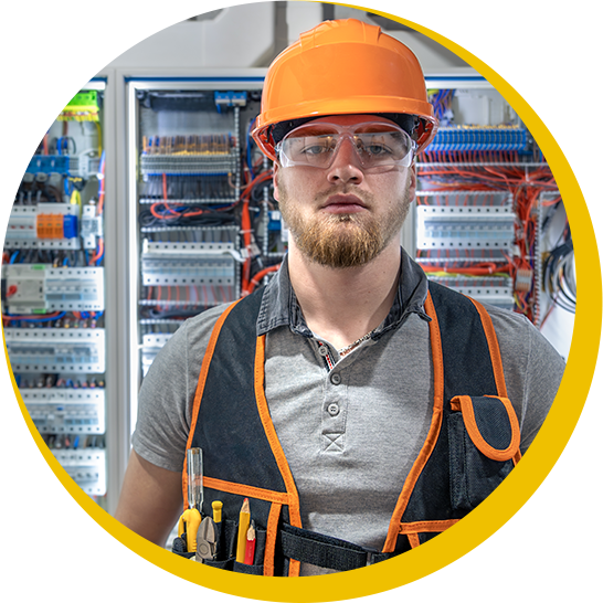 A man wearing an orange hard hat and safety glasses