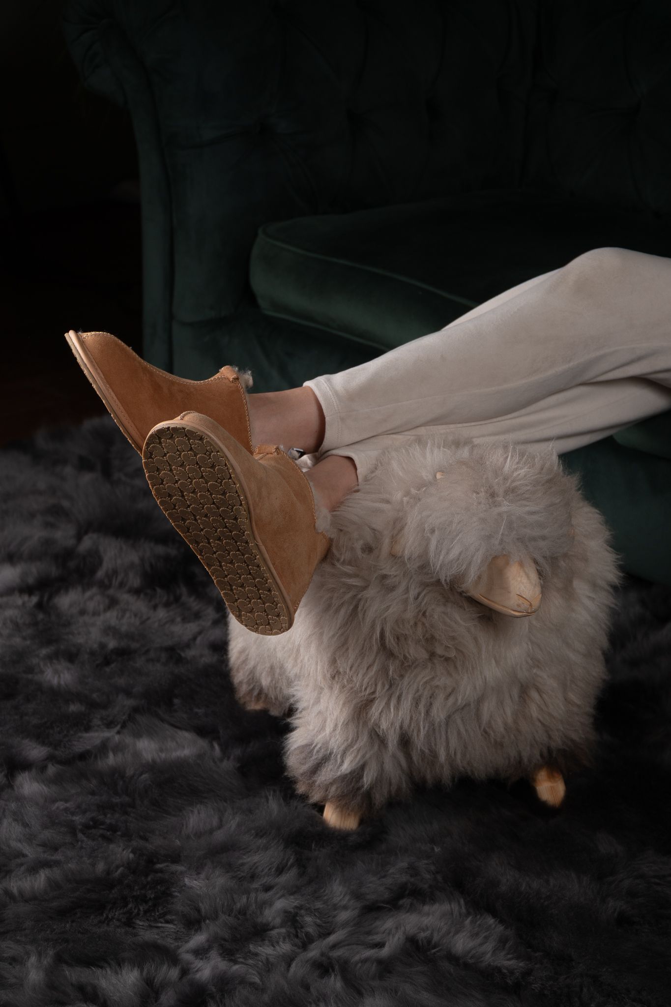 Sheepskin slippers styled in a dark luxury interior