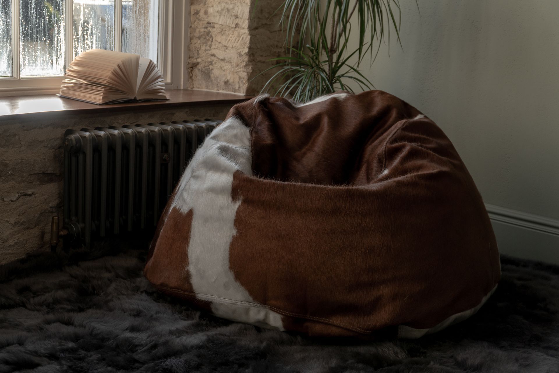 Brown and cream sheepskin beanbag in a rustic home interior