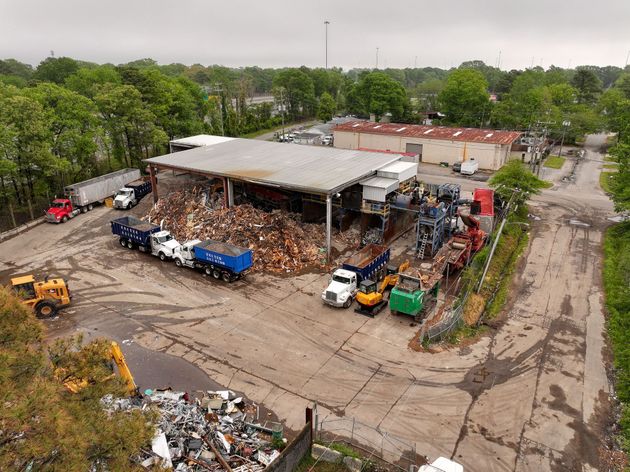 An aerial view of a recycling facility with trucks and tractors.