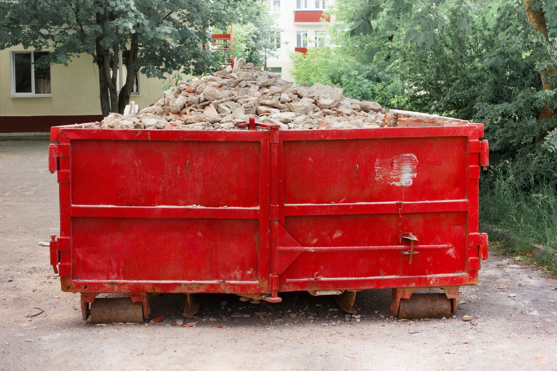 A red container with solid domestic and construction waste.
