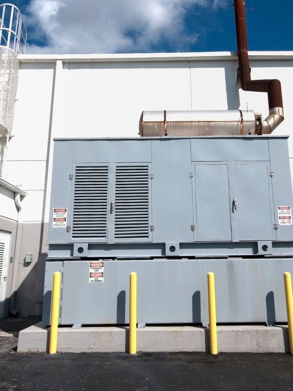 Certified electrician installing a commercial backup generator system