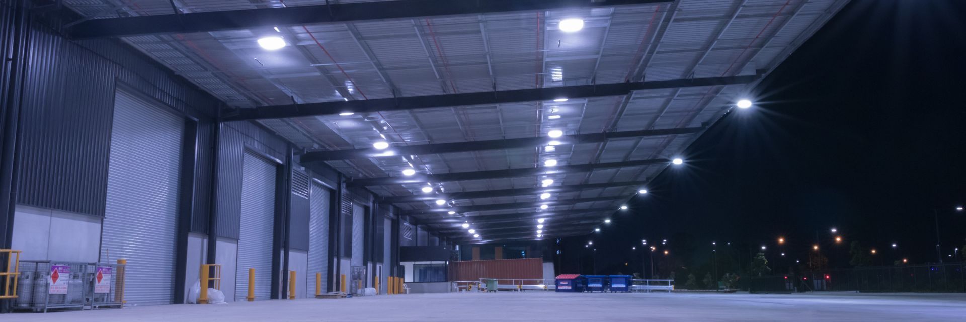 Exterior lighting installed on commercial building at dusk
