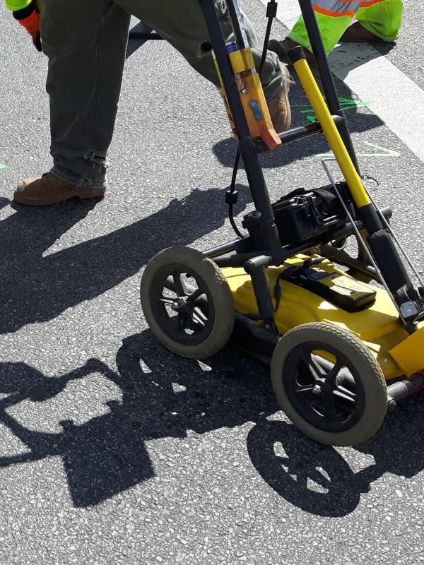 Technician performing underground utility locating and circuit tracing