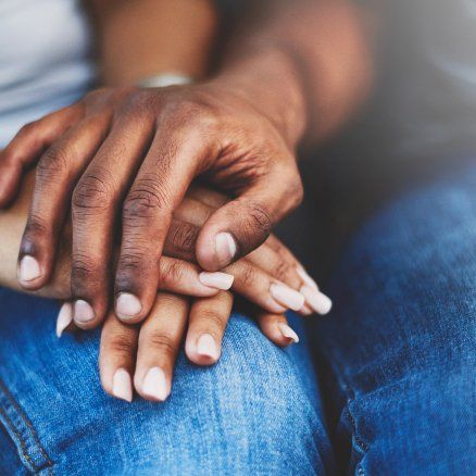 A close up of a person 's hands on their lap.