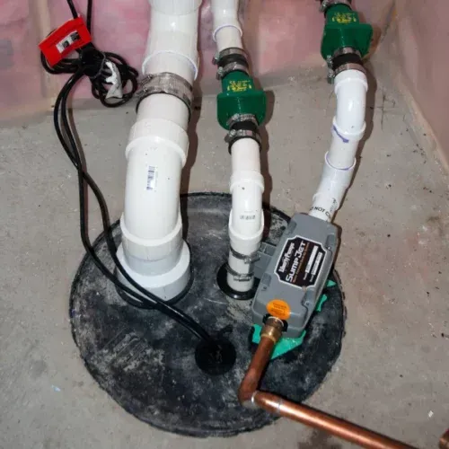 A sump pump is connected to several pipes including one that says ' simpson ' on it