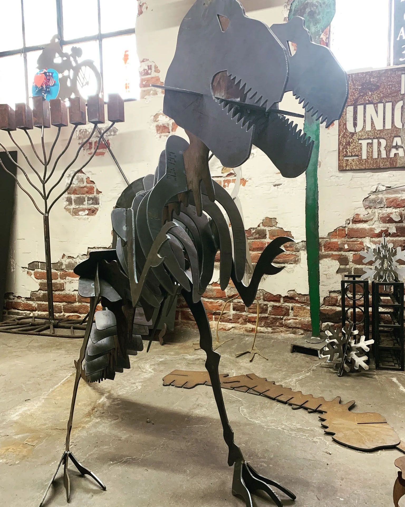 A large statue of a dinosaur is in a room with a sign that says union