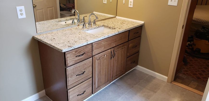 A bathroom vanity with a sink and a mirror.