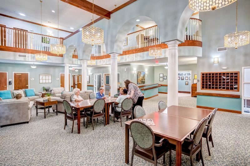 A group of people are sitting at tables in a large room.