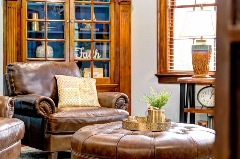 A living room filled with furniture and a large ottoman.