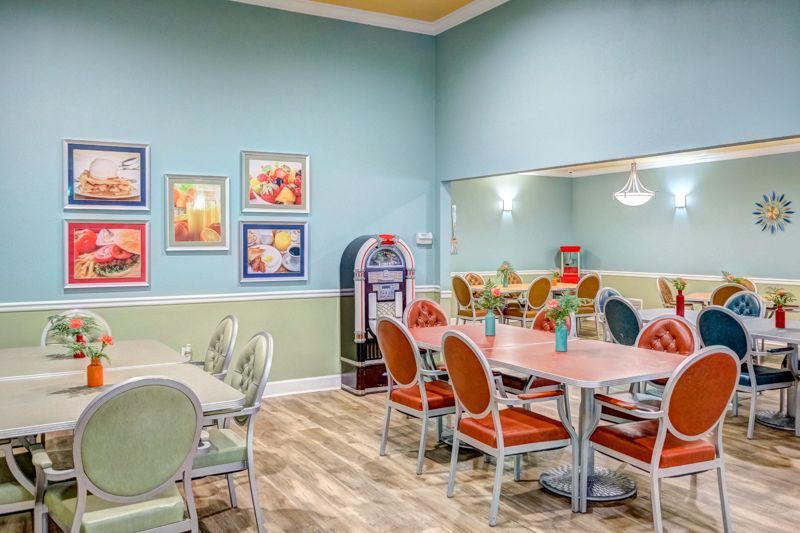 A dining room with tables and chairs and a jukebox.