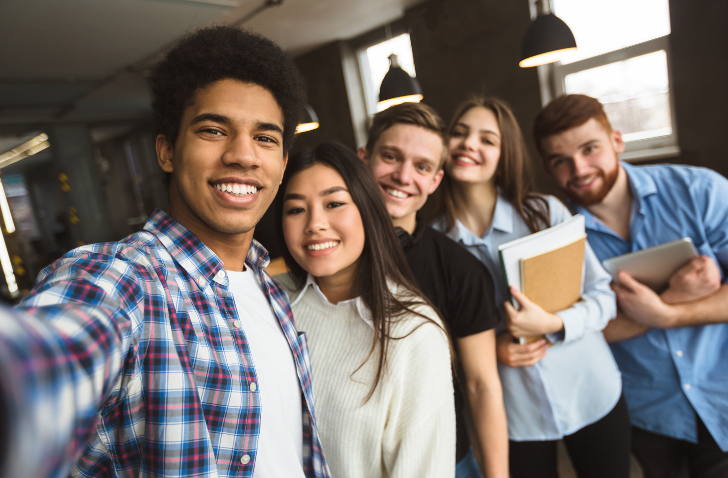 A group of young people are taking a selfie together.