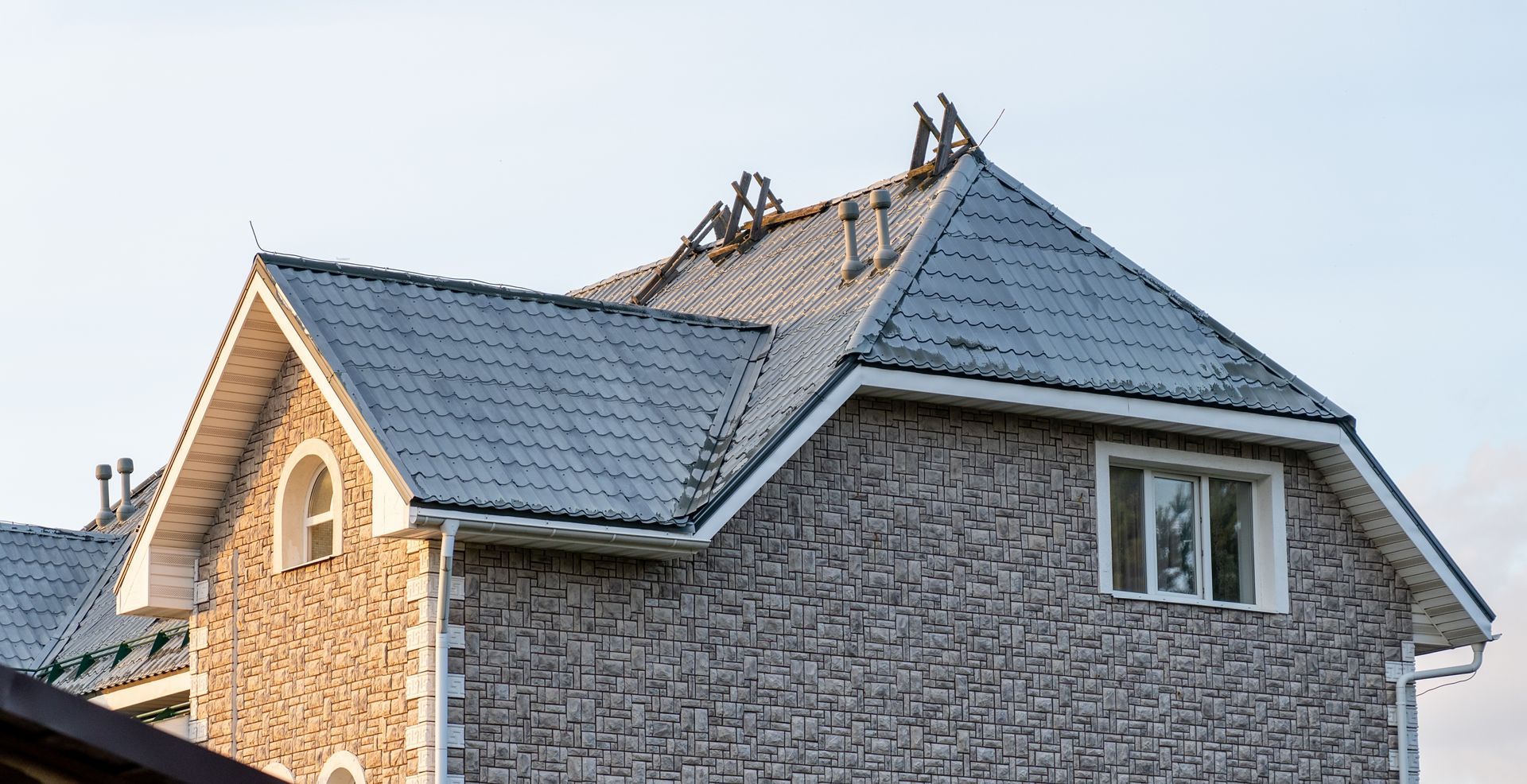 Close-up of reddish clay roof tiles with a few cracked and missing pieces on a tiled roof Close-up of reddish clay roof tiles with a few cracked and missing pieces on a tiled roof