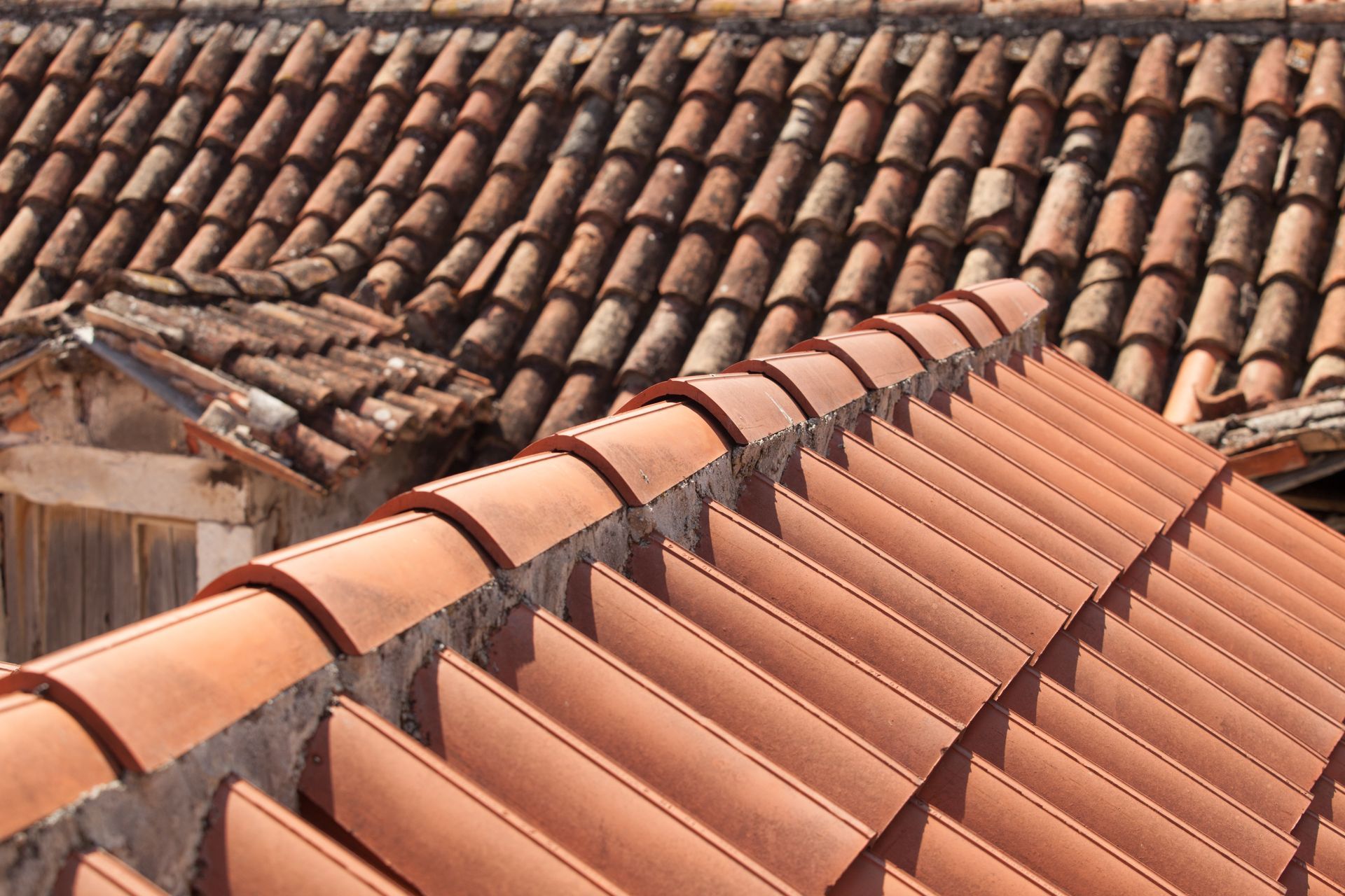 Orange and brown tiled rooftops overlapping in a close-up view Orange and brown tiled rooftops overlapping in a close-up view