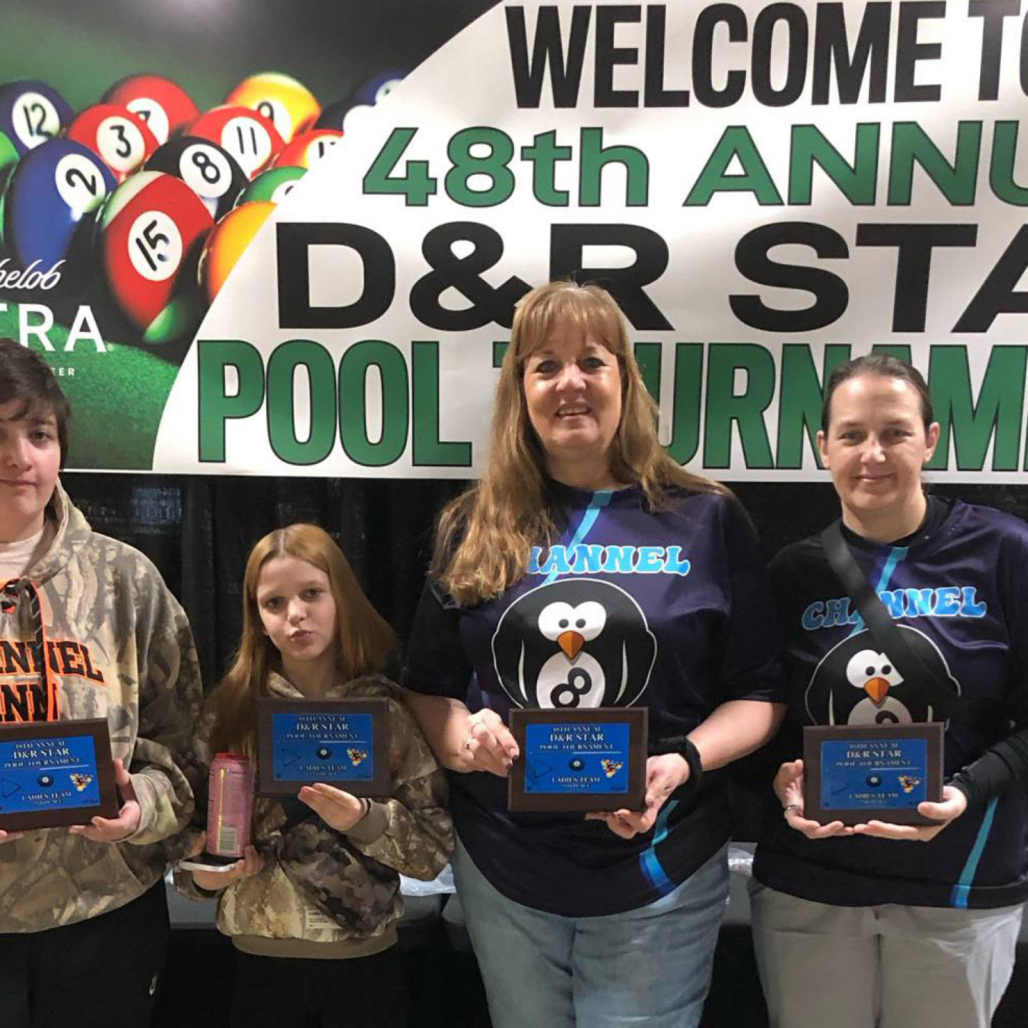 Four people holding plaques at the 