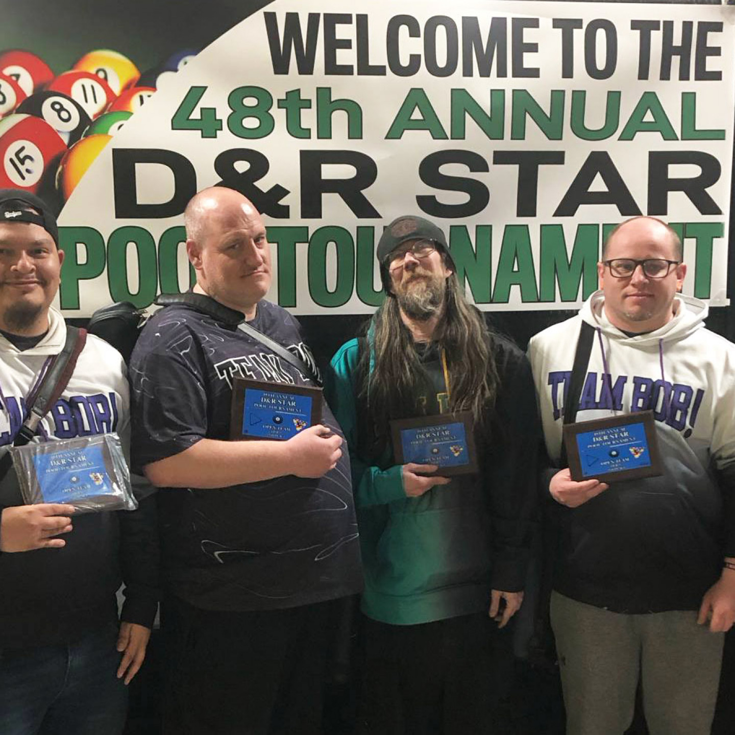 Four men holding trophies at the 48th Annual D&R Star Pool Tournament.