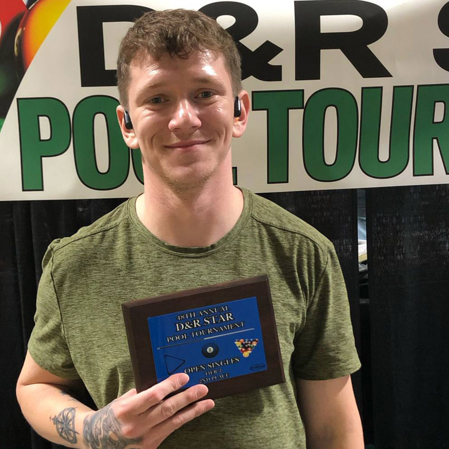 Man holding a plaque with 