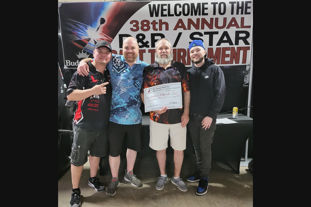 Four men smiling, holding an award at the 38th Annual F&P/STAR Tournament.