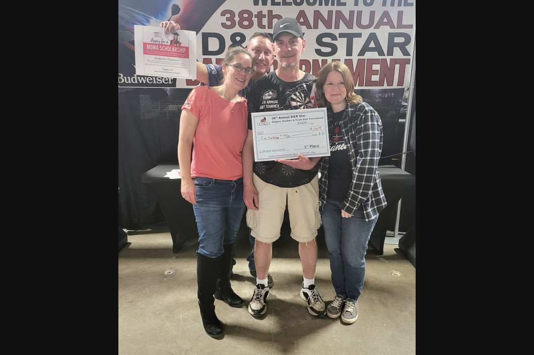 Three people posing with a certificate at a dance competition. Banner reads 