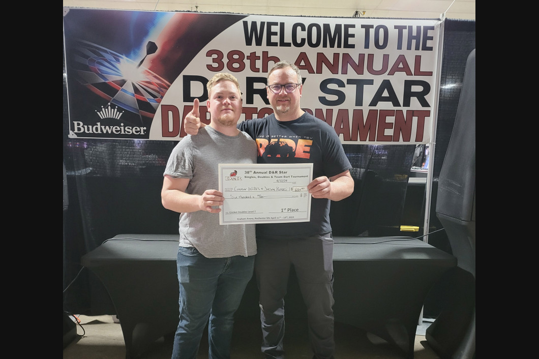 Two men holding a large check at the 