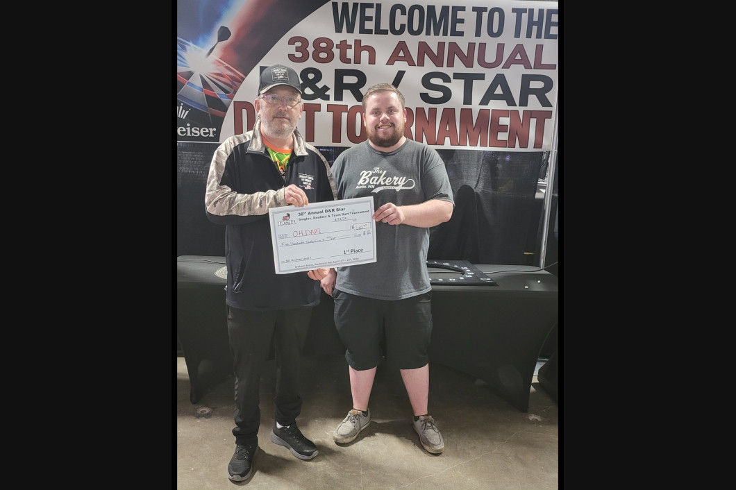 Two men holding a certificate at the 38th annual D&R Star Dart Tournament.