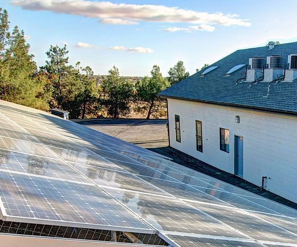 A house with a lot of solar panels on the roof