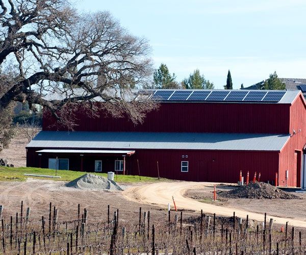 A red barn with solar panels on the roof