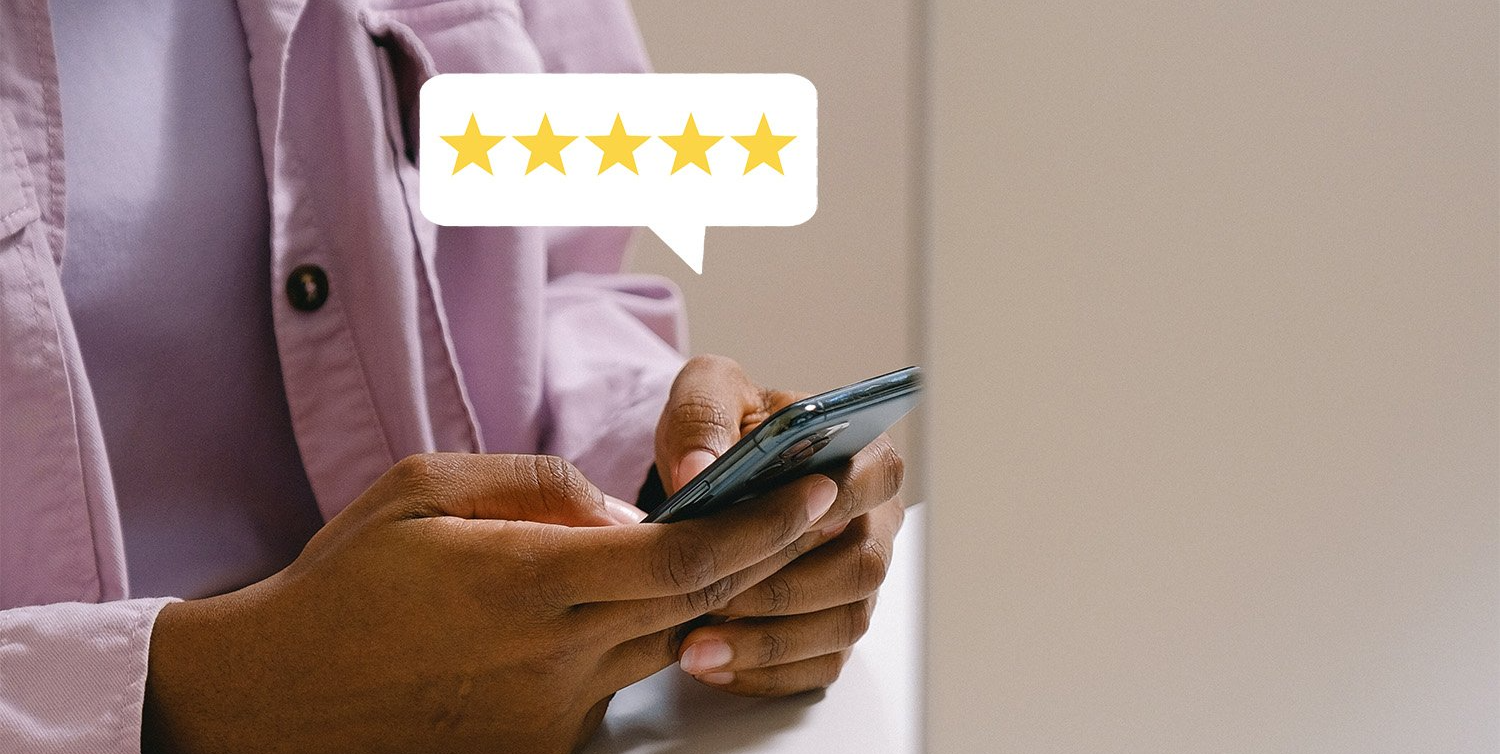 A person is using a cell phone with a speech bubble that says five stars.