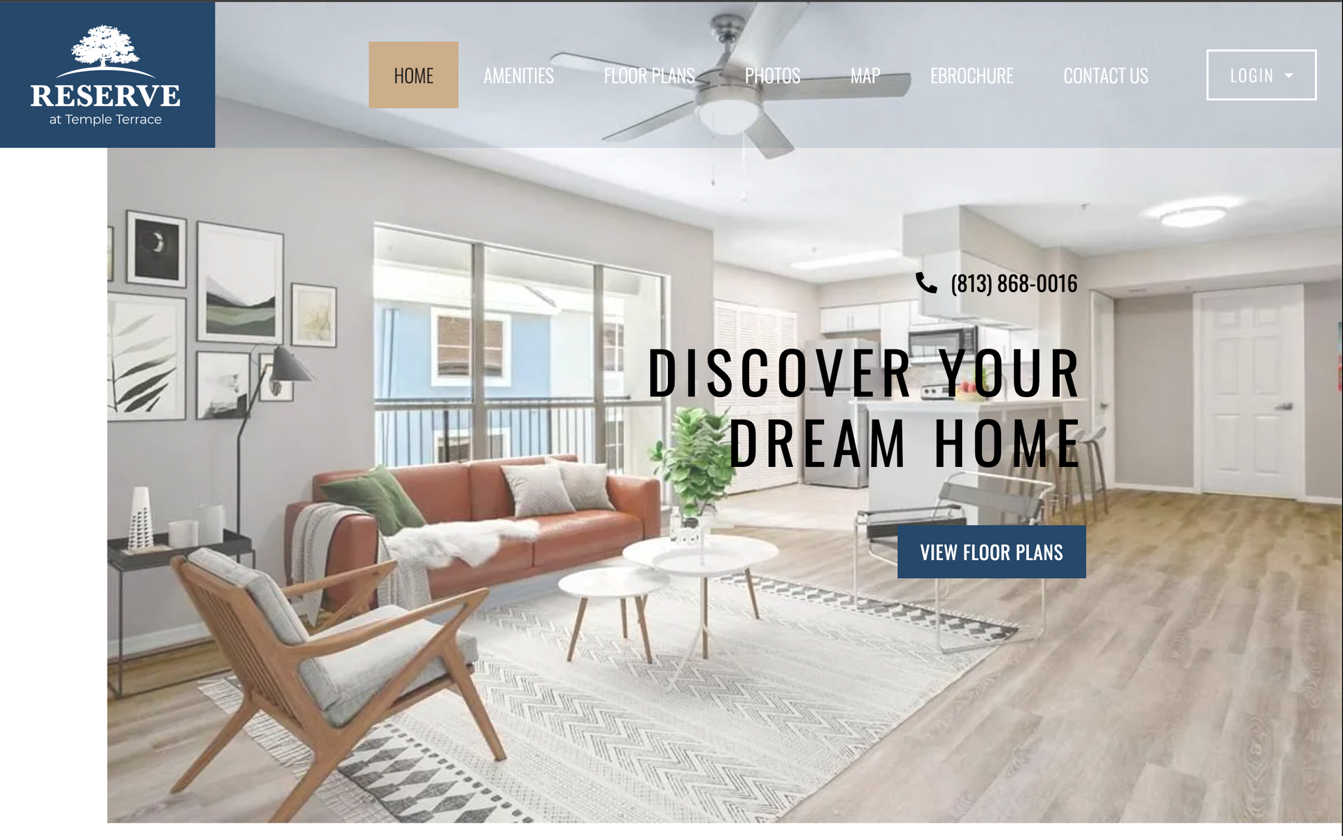 The homepage of a real estate website shows a living room with a couch and chairs.