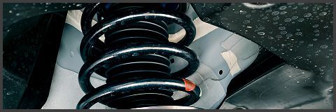 Mechanic holding car differential gear, working on vehicle parts in shop. | Lains Auto Services