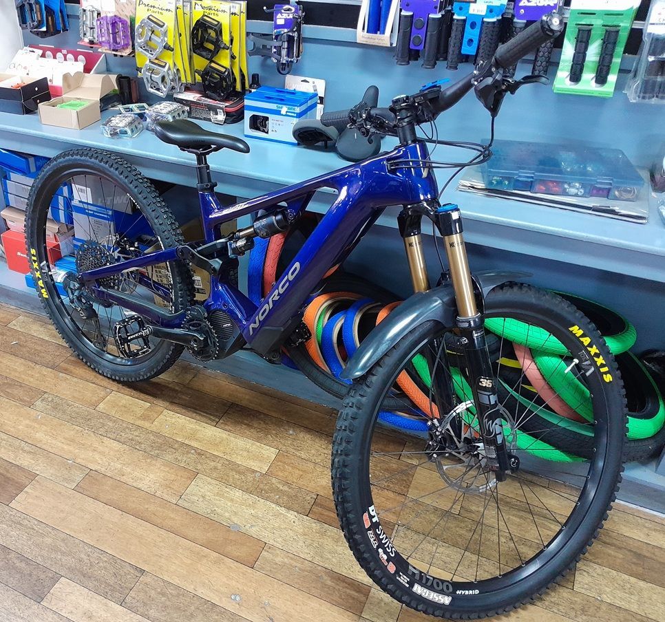 Black and Teal Mountain Bike Against a Brick Wall — City Centre Cycles in Berserker, QLD