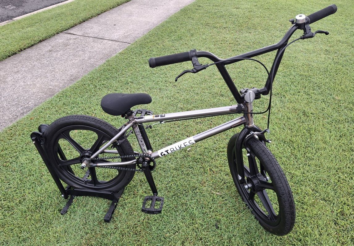 Black BMX Bike on Grass Beside a Sidewalk, Viewed from The Side — City Centre Cycles in Berserker, QLD