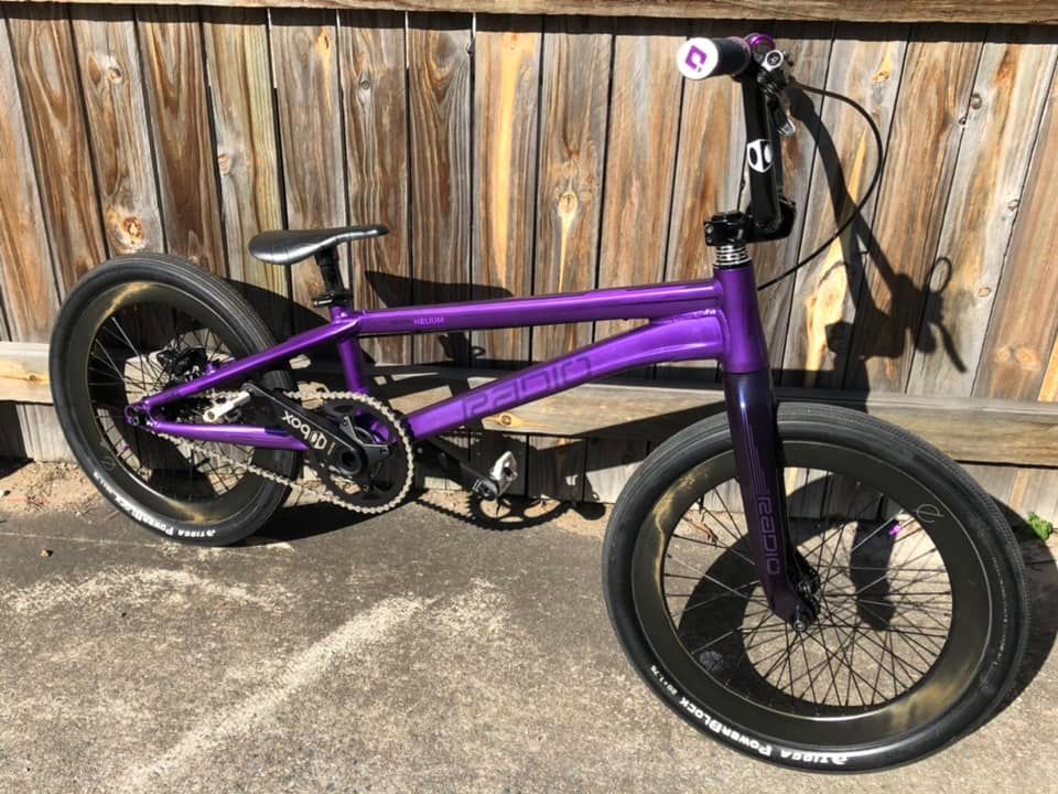 Purple BMX Bike with Fat Tires Parked on Pavement in Front of A Wooden Fence — City Centre Cycles in Berserker, QLD