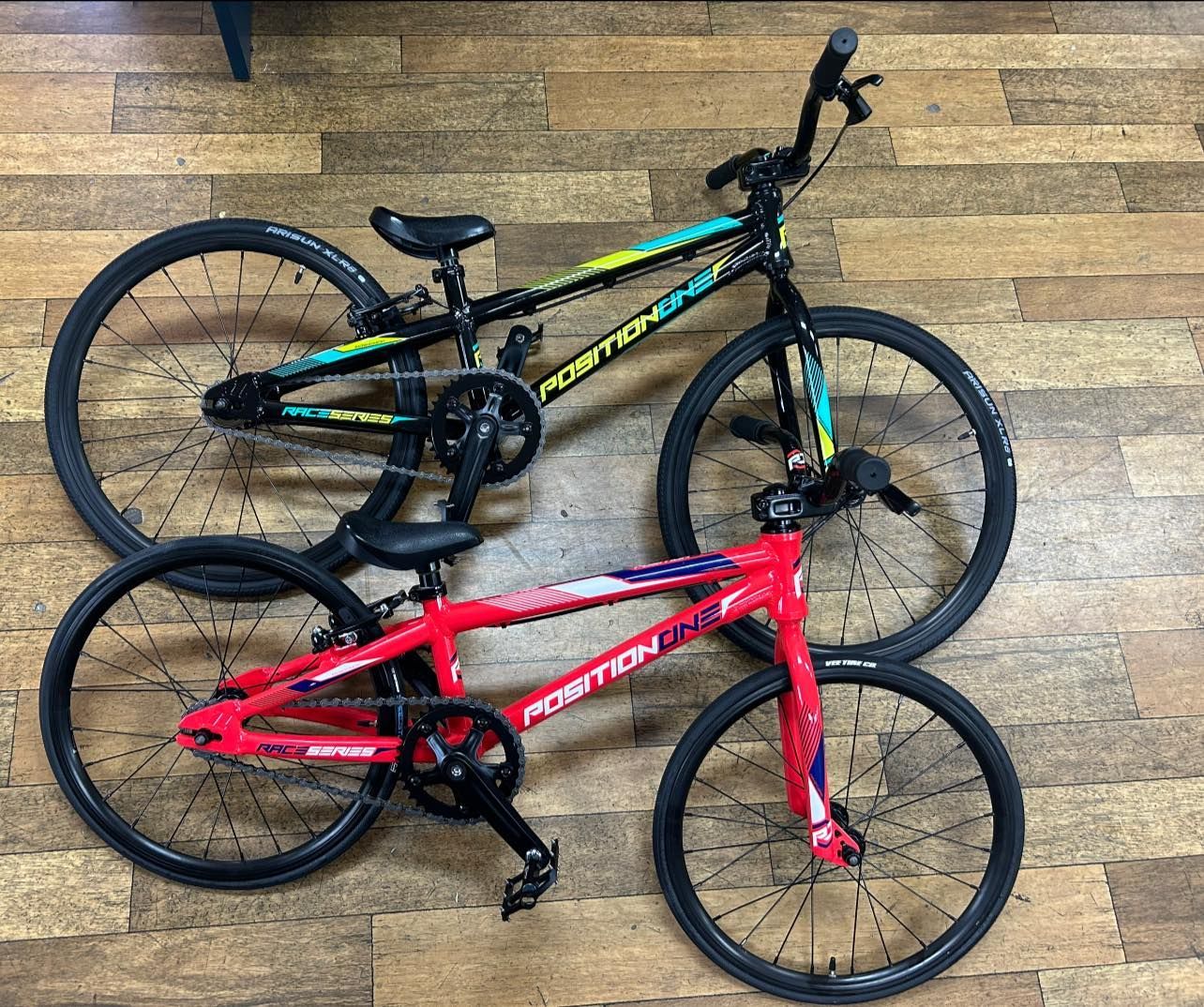 Two Mountain Bikes, One Red and One Black with Green Accents — City Centre Cycles in Berserker, QLD