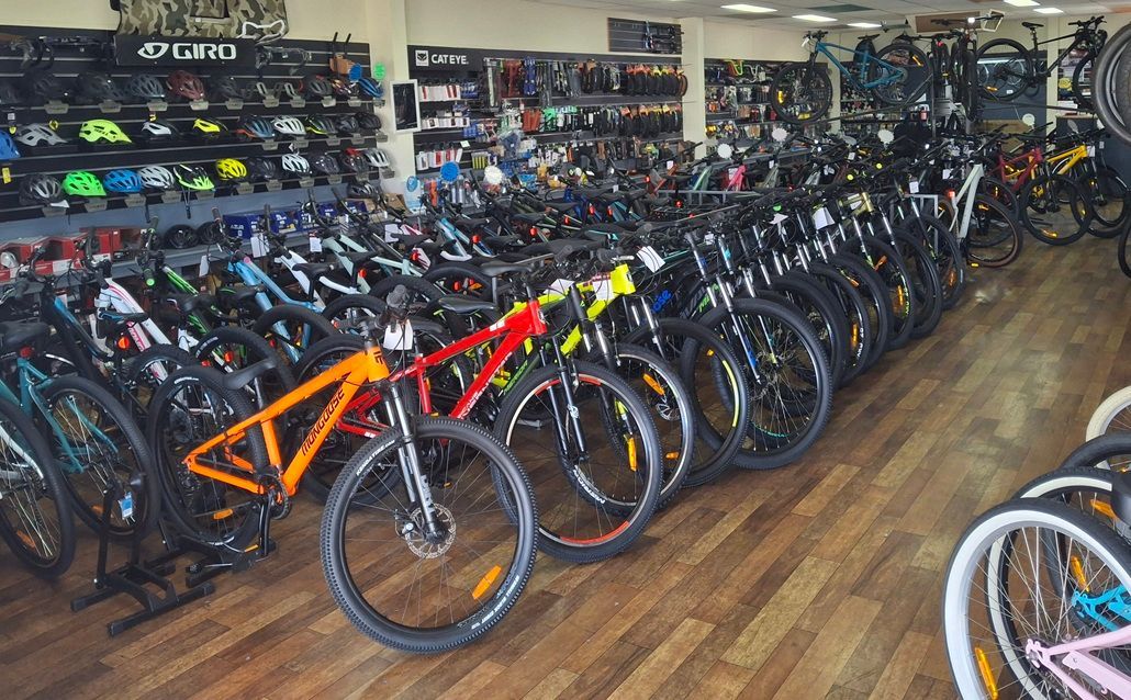 Bicycle Shop Interior with Rows of Colourful Bikes Lined up On Wooden Floors — City Centre Cycles in Berserker, QLD