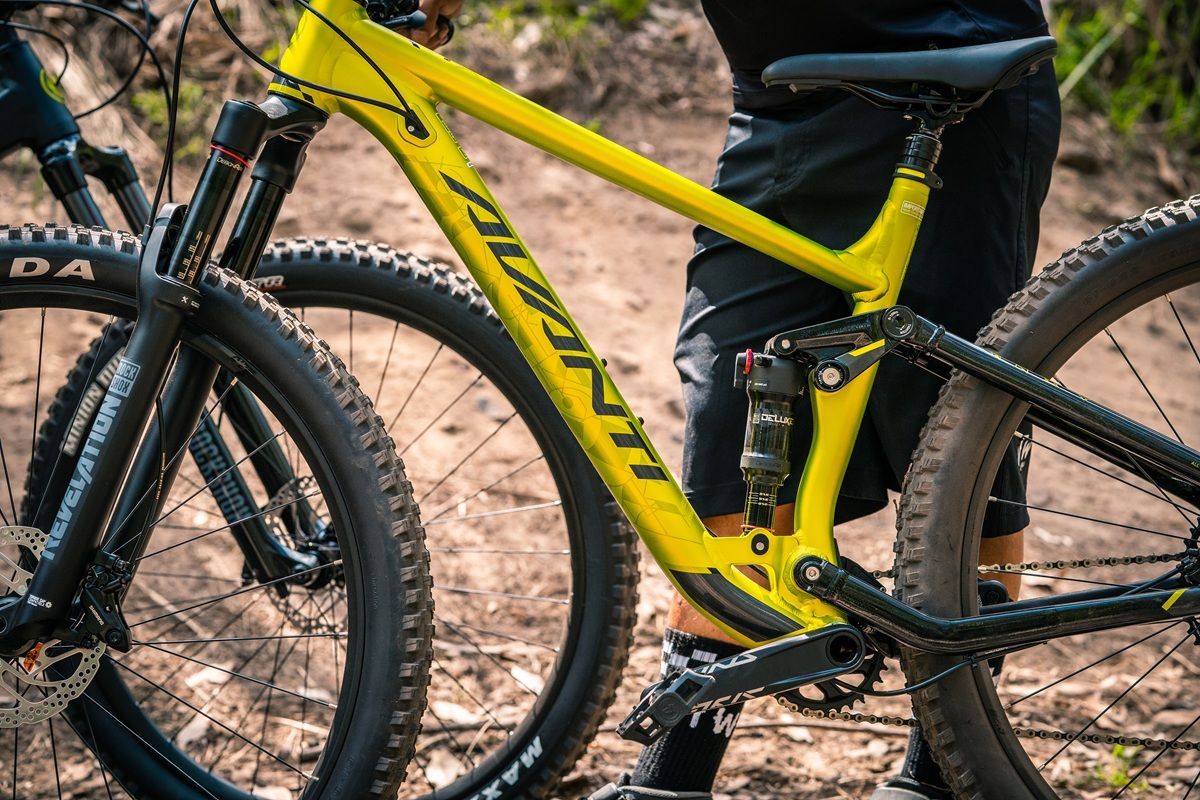 Yellow Mountain Bike on A Dirt Trail and Close Up of The Frame and Rear Wheel — City Centre Cycles in Berserker, QLD