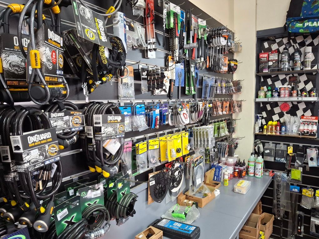 Hardware Store Aisle with Hanging Tools then Cables and Accessories on Display Shelves — City Centre Cycles in Berserker, QLD