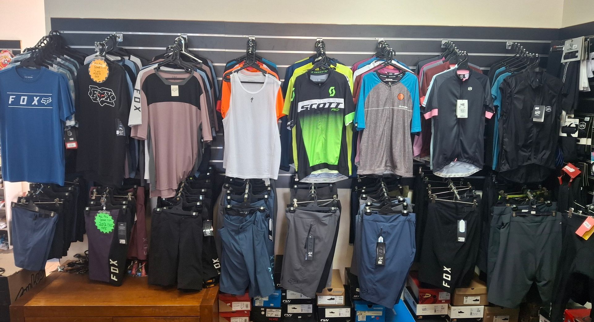 Motorcycle Apparel Display with Jerseys and Riding Pants Hanging in A Shop — City Centre Cycles in Berserker, QLD