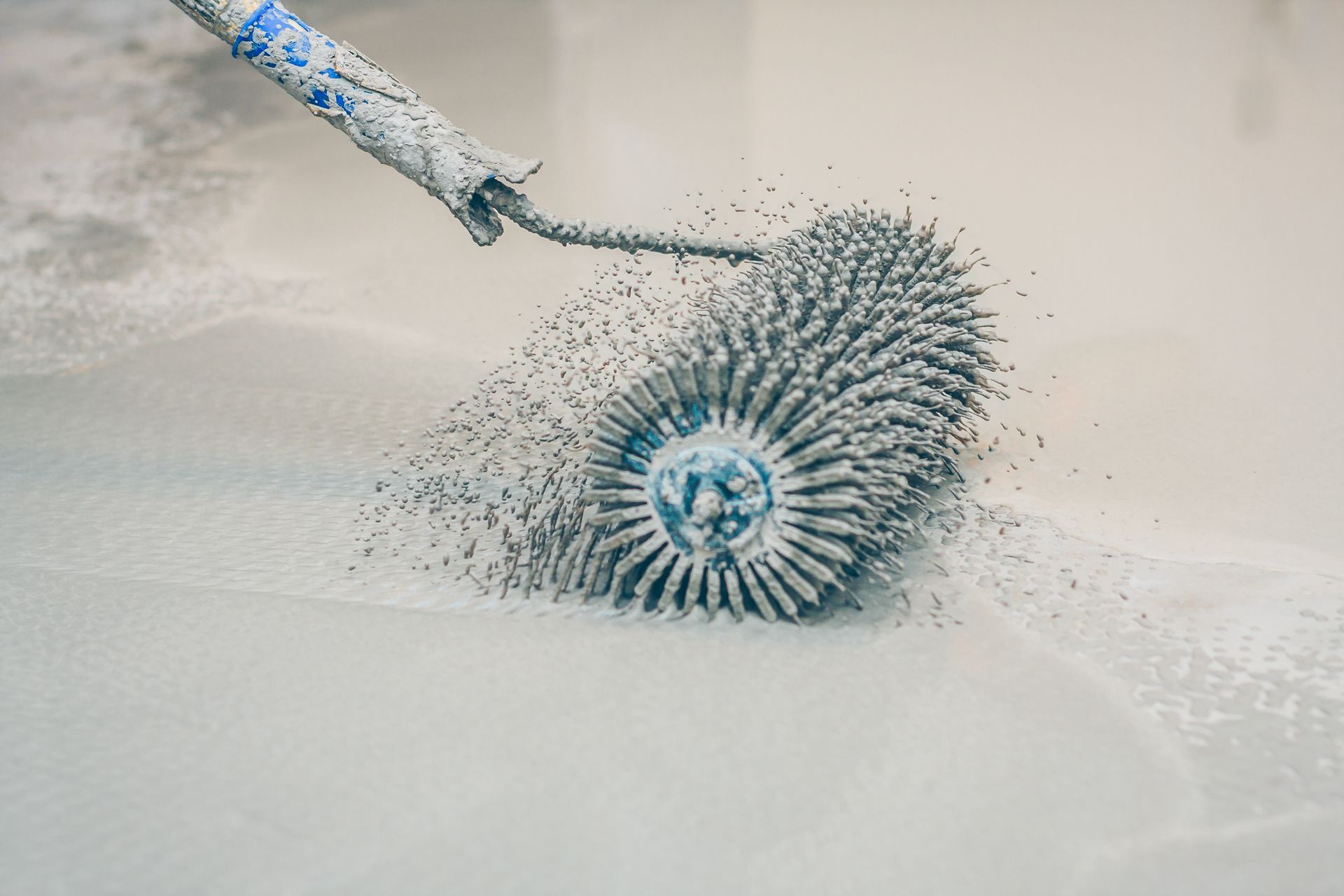 Roller tool with many spikes rolling over light gray surface. Roller tool with many spikes rolling over light gray surface.