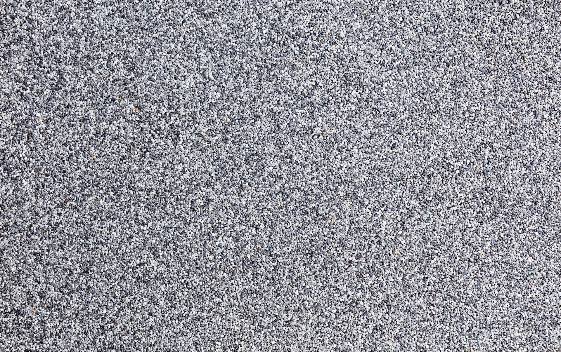 Close-up view of a surface with a speckled, granular pattern in shades of gray.