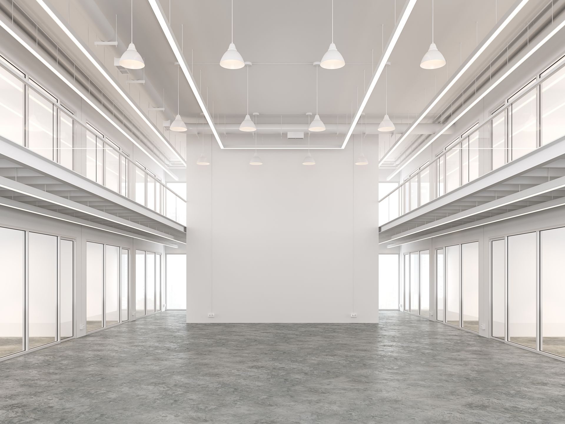 Empty, modern warehouse interior with two-story balconies and white walls. Concrete floor, hanging lights.